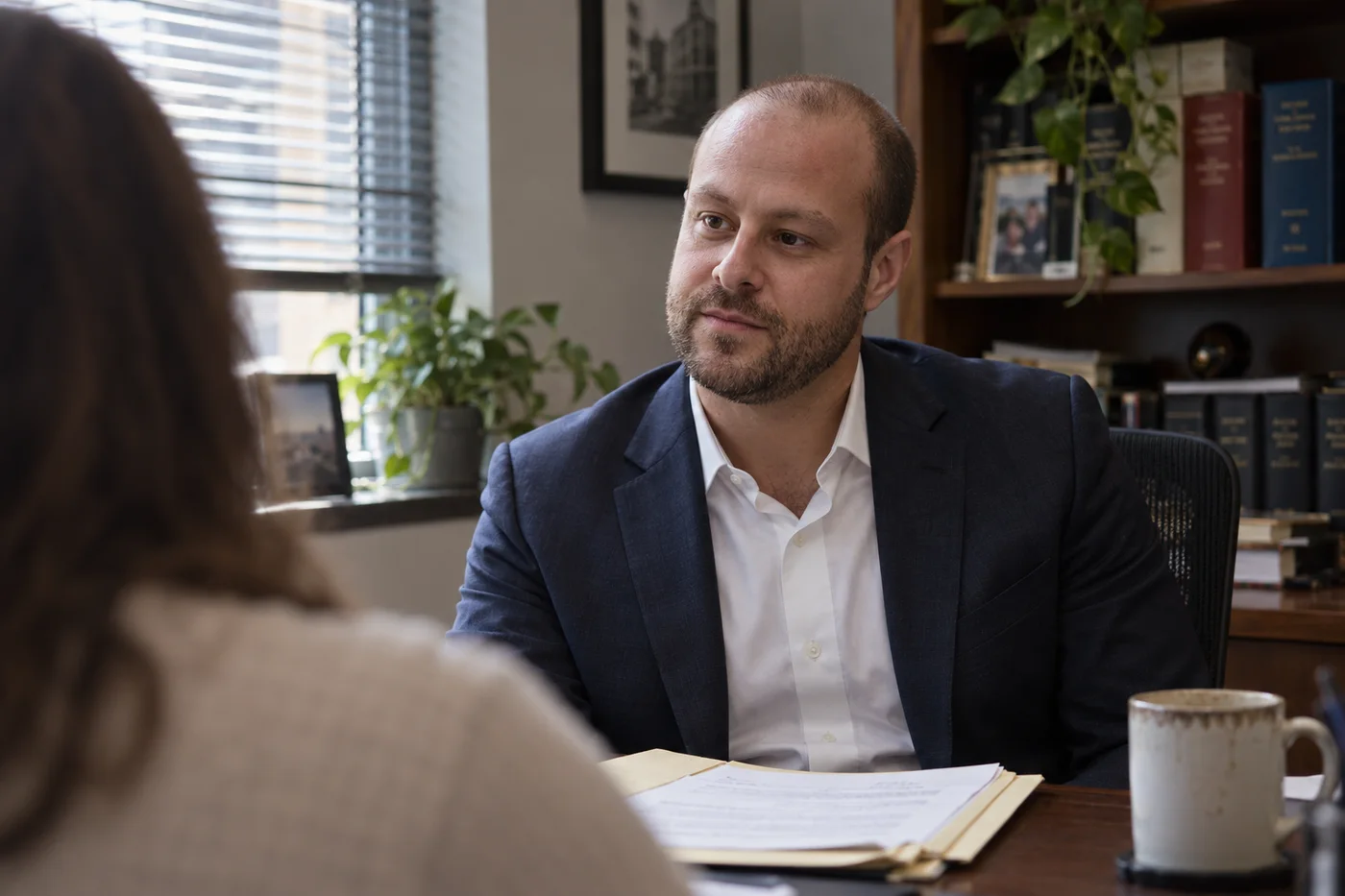 Portrait of Joshua Butnick seated in office during client consultation