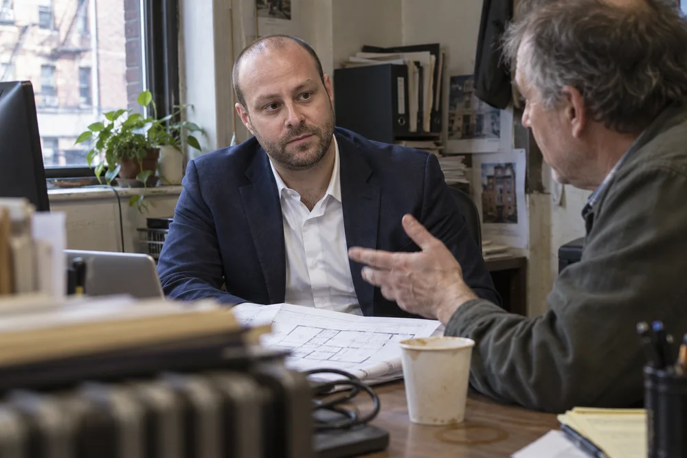 Joshua Butnick and a commercial landlord discussing building strategy at property desk